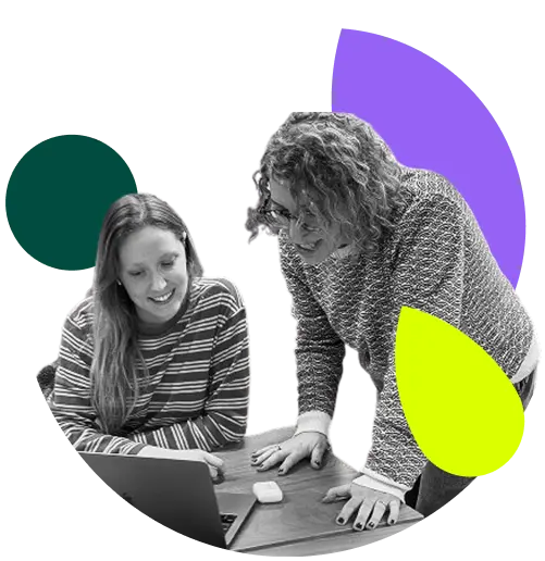 Two men working on laptops, with abstract colourful shapes (purple circle, green leaf, and yellow leaf) in the background.