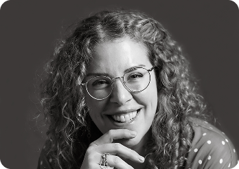 Black and white image of a woman (Elise, CPO at Systemseed) smiling.