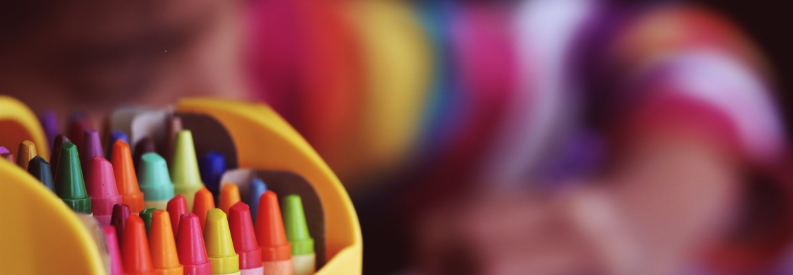 Child coloring with crayons 