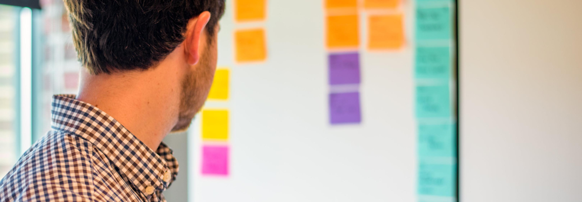 Man looking at SCRUM board