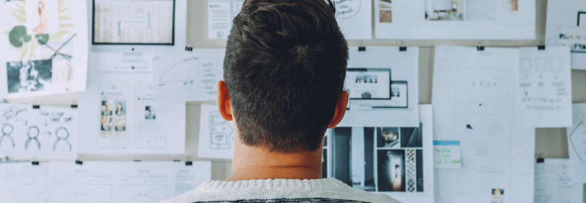 Man looking at wall of design and prototype elements