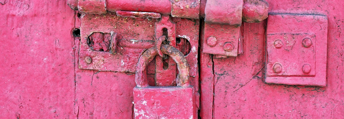 Red padlock on a red door