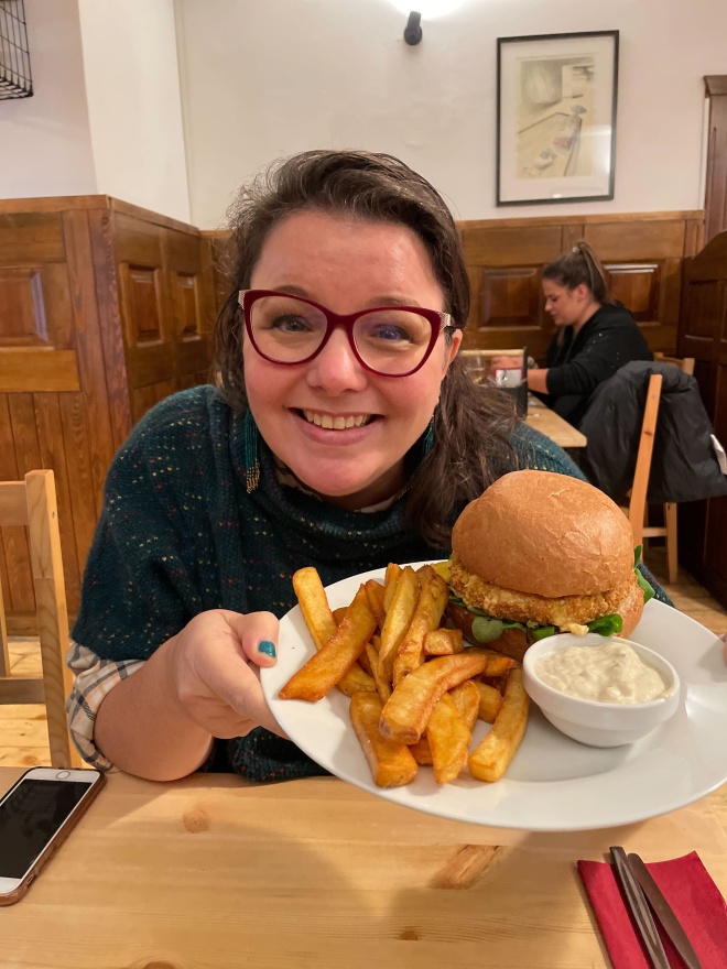 Deep fried cheese in a bun, with chips - and Tam looking very happy about it